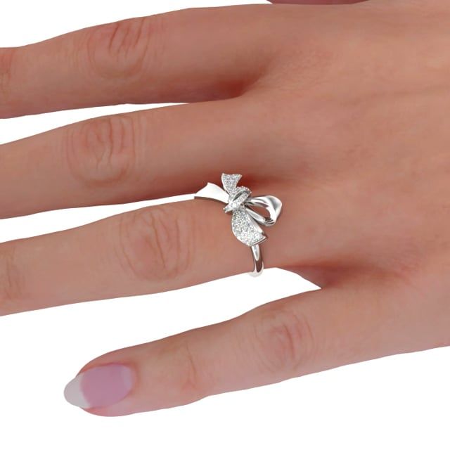 unknown – An exquisite round brilliant cut pave diamond bow ring in platinum