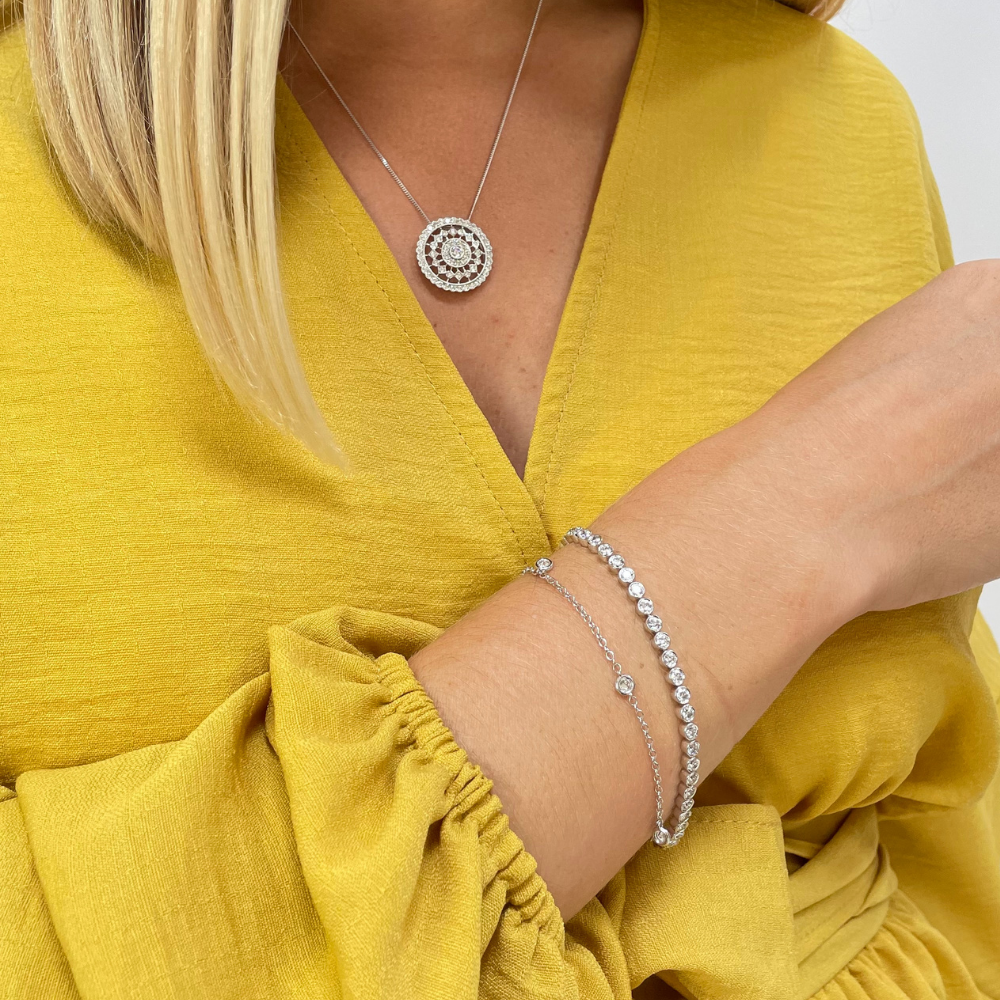 [OTHER IMAGE] two-side-view – A stunning round brilliant cut diamond bracelet in a rub-over setting in 18ct white gold